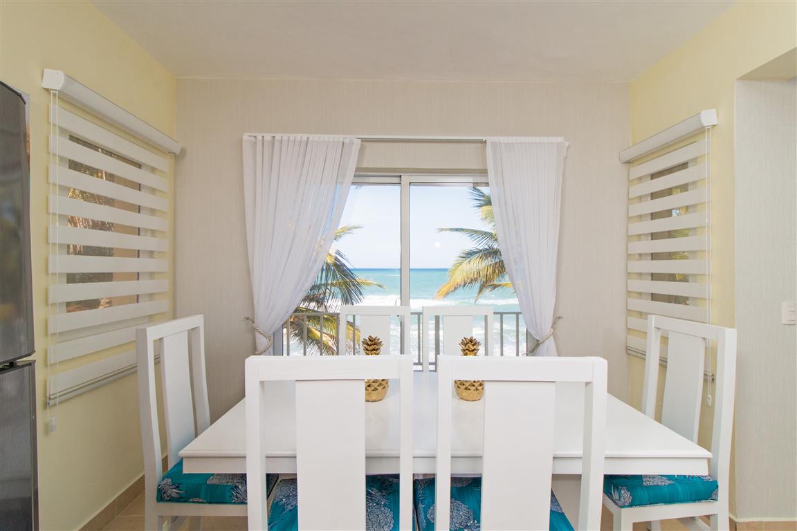 Beachfront dining area with ocean view at Beach Condos La Rinconada, Cabarete